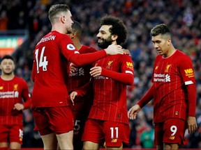 Liverpool's Mohamed Salah celebrates scoring against Southampton with Jordan Henderson and teammates on Feb. 1, 2020 at Anfield.