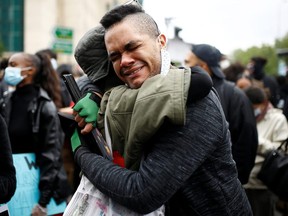 Demonstrators are seen embracing during a Black Lives Matter protest in London, June 6, 2020.
