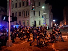 Kentucky State Troopers advance and detain a man during the protest against the deaths of Breonna Taylor by Louisville police and George Floyd by Minneapolis police, in Louisville, Ky. June 1, 2020.