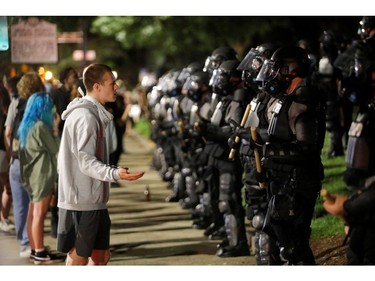 A protester pleads with riot police during nationwide unrest following the death in Minneapolis police custody of George Floyd, in Raleigh, North Carolina, U.S. May 31, 2020. Picture taken May 31, 2020. REUTERS/Jonathan Drake ORG XMIT: JAD106