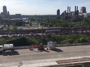 A tanker truck drives through thousands of people marching on a highway to protest the death of George Floyd in Minneapolis, Minnesota, U.S. May 31, 2020 in this still image obtained from social media video.