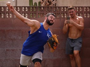 Pitcher Jakob Junis of the Kansas City Royals throws in front of Seth Blair of the San Diego Padres during a back yard training session on June 5, 2020 in Scottsdale, Arizona.