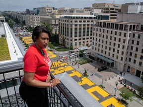 Mayor Muriel Bowser looks out over the words Black Lives Matter painted on a street, during nationwide protests against the death in Minneapolis police custody of George Floyd, in Washington, D.C., Friday, June 5, 2020.