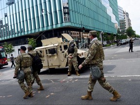 In this file photo, members of the National Guard patrol a street near the White House on June 2, 2020 in Washington.