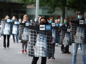 Demonstrators hold images of mink during a protest calling for an end to the fur trade, following the decision of the Dutch government to cull thousands of mink on farms where animals are infected with COVID-19, in The Hague, Netherlands.
