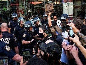 Demonstrators scuffle with NYPD officers as they try to march trough Times Square during a protest against racial inequality in New York June 14, 2020.