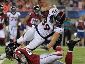 Broncos tight end Austin Fort (89) is tackled by Falcons defensive back Parker Baldwin (43) during the Pro Football Hall of Fame Game at Tom Benson Hall of Fame Stadium in Canton, Ohio, Aug. 1, 2019.