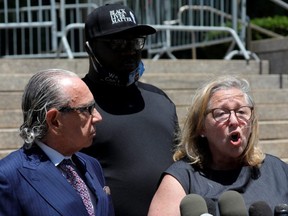 Attorney Lori Zeno speaks to reporters alongside activist Rev. Kevin McCall (centre) and attorney Sanford Rubenstein outside Queens Criminal Court, following a hearing in the case of New York Police Department officer David Afanador, who was arrested for using an illegal chokehold to arrest a man, in New York City, Thursday, June 25, 2020.