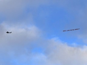 A plane flies over the stadium with a banner reading 'White Lives Matter Burnley'  during the Premier League match between Manchester City and Burnley FC at Etihad Stadium on June 22, 2020 in Manchester.