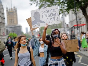Protestors march down Whitehall during an anti-racism demonstration in London, on June 3, 2020.