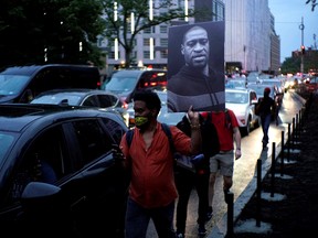A protester holds up a portrait of George Floyd, who died in Minneapolis police custody, during a protest against his death, in New York City, New York, U.S., June 5, 2020.