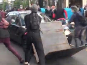 A car crashes into a barricade set up by protesters, moments before a man exits the vehicle holding a gun, during a protest against racial inequality in the aftermath of the death in Minneapolis police custody of George Floyd, in Seattle June 7, 2020, in this still image taken from video obtained from social media.