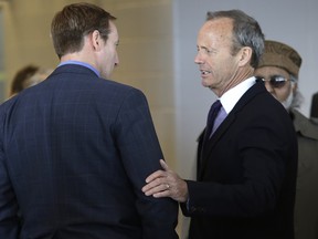 Minister of Justice Peter MacKay, left, speaks with Stockwell Day at the Jim Flaherty visitation at  Abilities Centre in Whitby Ont., April 15, 2014.