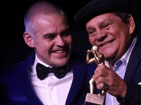 In this file photo taken July 27, 2017, former boxing champion Roberto Duran (right) and former boxer Gilberto Mendoza hold up a trophy at the opening Gala of 96th World Boxing Association Convention in Medellin, Colombia.