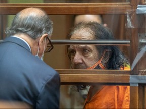 Adult film star Ron Jeremy, who is charged with raping three women and sexually assaulting a fourth in incidents in West Hollywood from 2014 to 2019, talks with his attorney Stuart Goldfarb during an arraignment hearing at Clara Shortridge Foltz Criminal Justice Center in Los Angeles June 26, 2020.