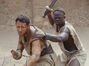 Maximus (Russell Crowe) and Juba (Djimon Hounsou) get down to business in the movie "Gladiator."