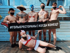 Employees of the Funky Food 11 restaurant wearing face masks pose for a photo without clothes to draw attention to a crisis in the restaurant industry caused by the lockdown measures imposed to prevent the spread of the coronavirus disease (COVID-19) in Krasnodar, Russia, in this undated picture obtained from social media. The banner reads: "Naked restaurants. When is the end?"