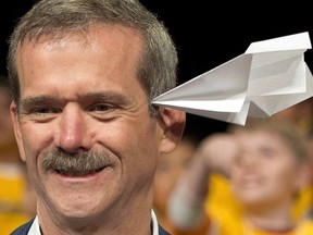 Retired Canadian astronaut Chris Hadfield is hit in the head by a paper airplane as he takes part in a paper airplane toss with students in Coquitlam, B.C. Thursday, April 17, 2014.