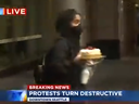 During live coverage of riots in Seattle, a woman can been seen swiping a cheesecake from the Cheesecake Factory. 