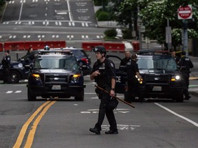 A police officer walks outside of the Seattle Police Departments West Precinct on June 10, 2020 in Seattle.