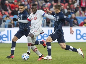 Toronto FC forward Jozy Altidore (17) drives between New York City defender Ronald Matarrita, left, and New York City midfielder James Sands (16) during first half MLS action in Toronto on Saturday March 7, 2020.