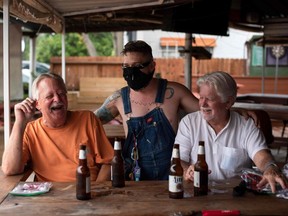 Patrons at the West Alabama Ice House have beers before Texas Governor Greg Abbott's order that all bars are to be closed at noon today, in Houston, Texas, Friday, June 26, 2020.
