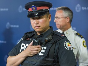 Toronto Police Service Const. Ben Seto with a body-worn camera during the announcement of the pilot project at police headquarters in Toronto, Ont. on Friday May 15, 2015.