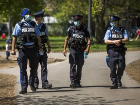 Police and Special Constables on patrol at Trinity Bellwoods Park in Toronto Sunday May 24, 2020.