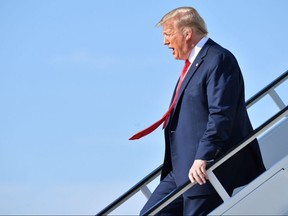 In this file photo taken on June 20, 2020 President Donald Trump steps off Air Force One at Tulsa International Airport on his way to his campaign rally at the BOK Center in Tulsa, Oklahoma.