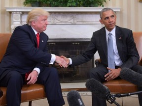 In this file photo taken on November 10, 2016, President Barack Obama and President-elect Donald Trump shake hands during a  transition planning meeting in the Oval Office at the White House in Washington.