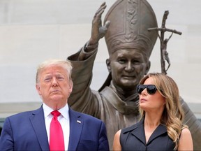 U.S. President Donald Trump and first lady Melania Trump pose during a visit to the Saint John Paul II National Shrine in Washington, June 2, 2020.
