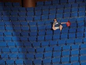 A supporter of President Donald Trump shoots a video with his mobile phone from the sparsely filled upper decks at the BOK Center in Tulsa, Oklahoma, June 20, 2020.