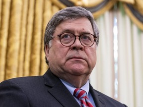 Attorney General William Barr listens as U.S. President Donald Trump speaks in the Oval Office before signing an executive order related to regulating social media in Washington, D.C., on May 28, 2020.
