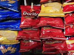 Bags of Doritos corn chips are displayed at a kiosk, in New York. Doritos are made by Frito-Lay, a division of PepsiCo.