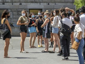 People line up for testing at Hôtel Dieu Hospital in Montreal Sunday July 12, 2020 the day after local health authorities said anyone who has been in a bar since July 1 should be tested for COVID-19.