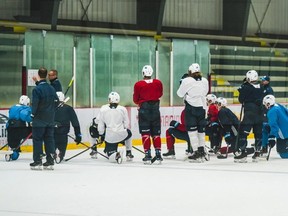 The Jets players listen as coaches explain a drill on Monday in the first day of training camp since the NHL paused the season. HANDOUT