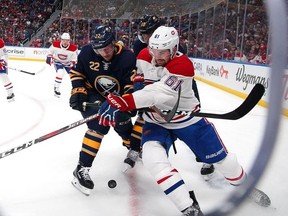 Johan Larsson of the Buffalo Sabres and Xavier Ouellet of the Montreal Canadiens battle for the puck during the second period at the KeyBank Center on October 25, 2018 in Buffalo, New York.