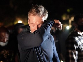 Portland Mayor Ted Wheeler reacts after being exposed to tear gas fired by federal officers while attending a protest against police brutality and racial injustice in front of the Mark O. Hatfield U.S. Courthouse on July 22, 2020 in Portland, Ore.