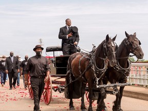 A horse drawn carriage carrying the body of civil rights icon, former U.S. Rep. John Lewis (D-GA) crosses the Edmund Pettus Bridge on July 26, 2020 in Selma, Alabama.