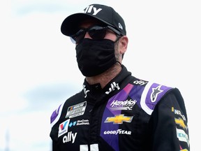 Jimmie Johnson, driver of the #48 Ally Chevrolet, walks on the grid prior to the NASCAR Cup Series Pocono 350 at Pocono Raceway on June 28, 2020 in Long Pond, Pennsylvania.