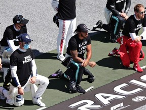 Lewis Hamilton of Great Britain and Mercedes GP, Pierre Gasly of France and Scuderia AlphaTauri  and some of the F1 drivers take a knee on the grid in support of the Black Lives Matter movement ahead of the Formula One Grand Prix of Austria at Red Bull Ring on July 05, 2020 in Spielberg, Austria.