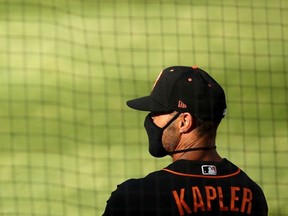 Manager Gabe Kapler of the San Francisco Giants stands in the dugout before their exhibition game against the Oakland Athletics at Oakland-Alameda County Coliseum on July 20, 2020 in Oakland, California.