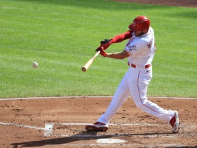 Mike Moustakas of the Cincinnati Reds hits a single in the first inning against the Detroit Tigers at Great American Ball Park on July 25, 2020 in Cincinnati, Ohio.