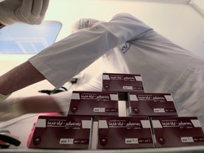 Lab technicians work on investigational coronavirus disease (COVID-19) treatment drug "Remdesivir" at Eva Pharma Facility in Cairo, Egypt, June 25, 2020.