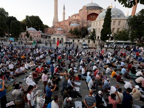 Muslims gather for evening prayers in front of the Hagia Sophia or Ayasofya, after a court decision that paves the way for it to be converted from a museum back into a mosque, in Istanbul, Turkey, July 10, 2020.