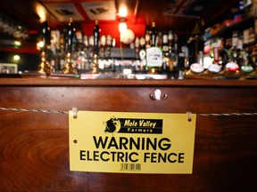 An electric fence installed at the bar area of The Star Inn, to ensure customers are socially distanced from staff while ordering drinks, following the outbreak of the coronavirus disease (COVID-19), in Cornwall, Britain July 14, 2020.