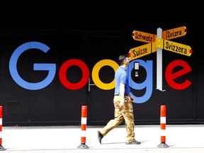 A man walks past a logo of Google in front of at an office building in Zurich, Switzerland July 1, 2020.