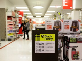 Customers shop during Black Friday sales soon after at a Target store opened for the day in Chicago, Ill., Nov. 29, 2019.