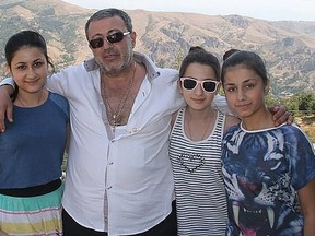 Mikhail Khachaturyan is seen in this undated photo with his three daughters who are accused of killing him.