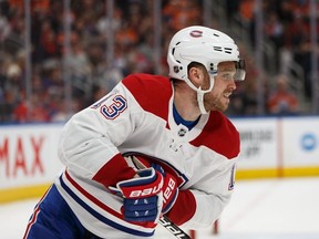 Montreal Canadiens' Max Domi (13) holds his hand after a hit by Edmonton Oilers' Gaetan Haas (91) during third period NHL hockey action at Rogers Place in Edmonton, on Saturday, Dec. 21, 2019.